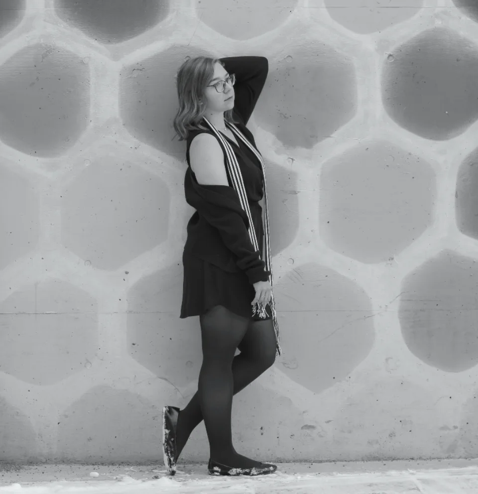 Black and white portrait against a patterned wall