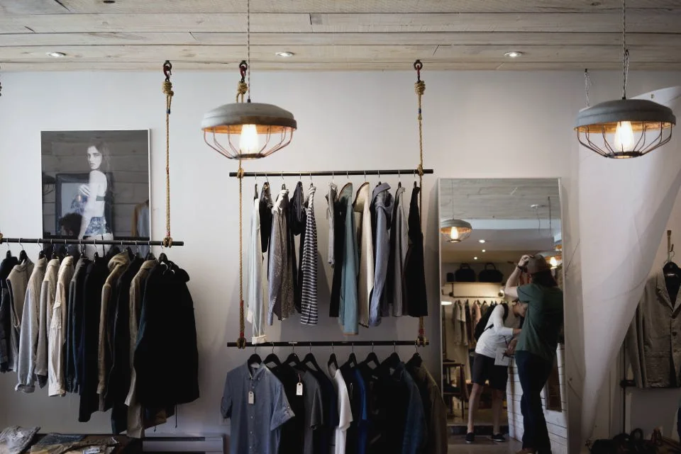 Bright clothing store with a few rails